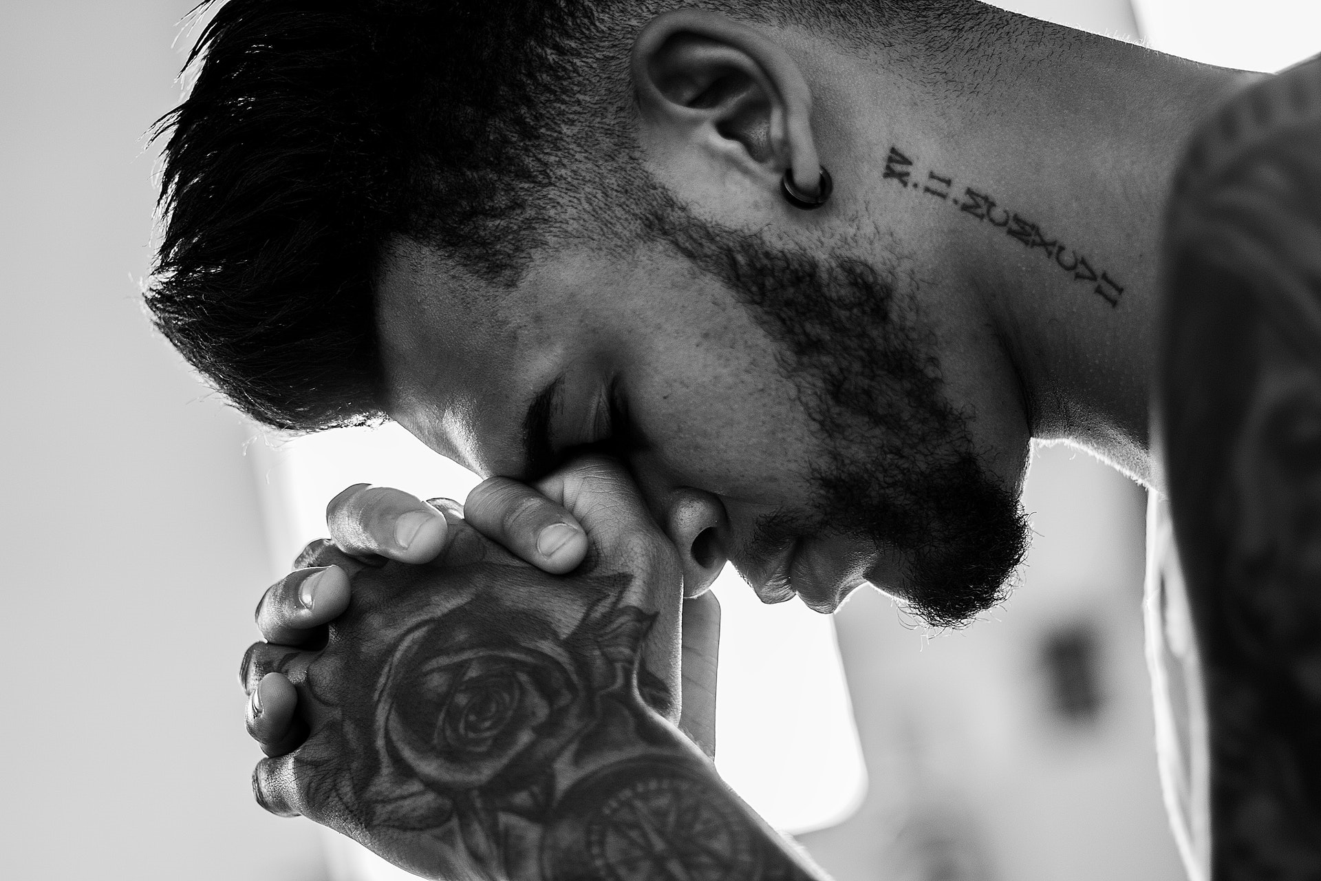 black and white photo of a man praying