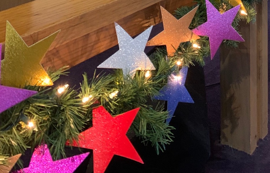 photo of garland with lights and paper stars