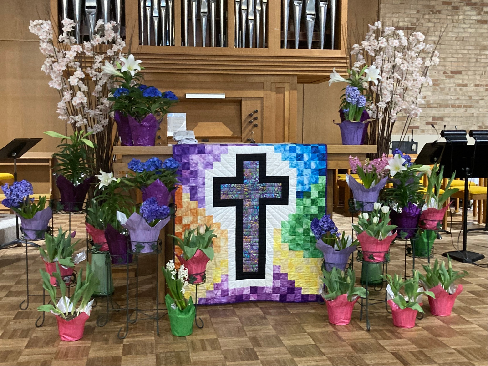 photo of hanscoms easter altar with flowers and a cross blanket