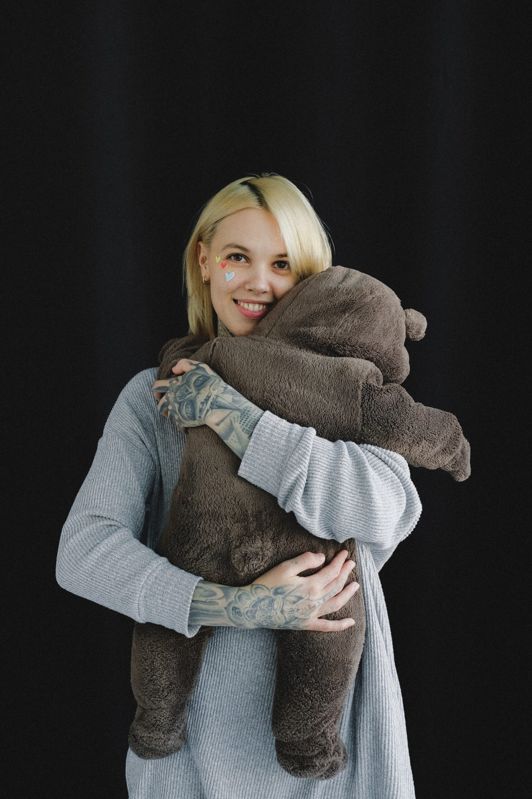 mother holding child in bear outfit